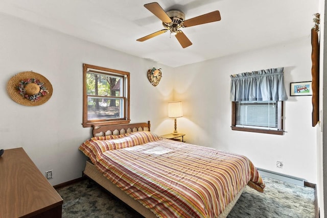 W11585 Demynck Rd, Lodi, WI 53555 - bedroom with ceiling fan, baseboards, baseboard heating, and dark colored carpet