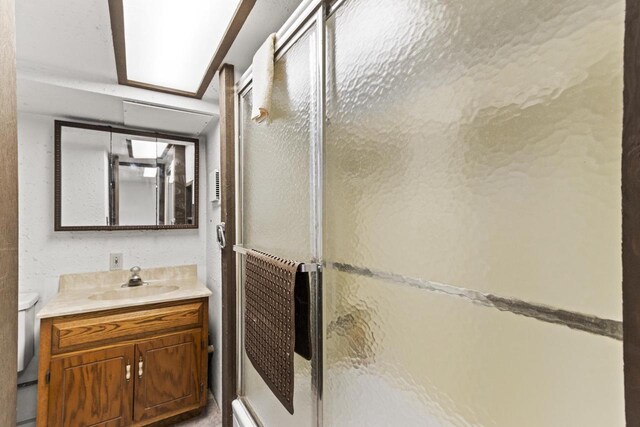 W11585 Demynck Rd, Lodi, WI 53555 - bathroom featuring toilet, a stall shower, and vanity