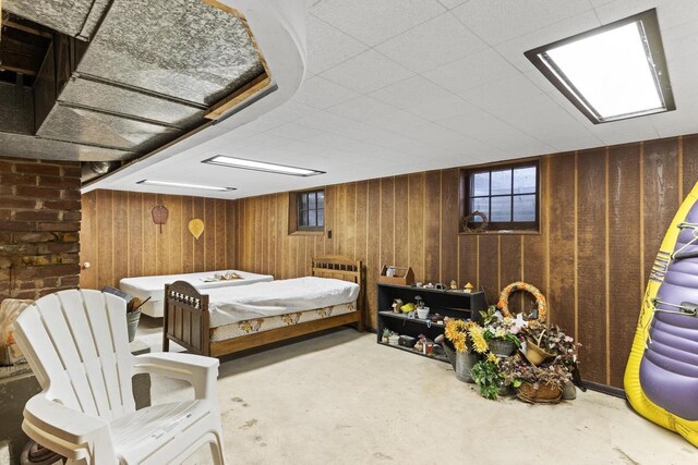 W11585 Demynck Rd, Lodi, WI 53555 - bedroom with unfinished concrete flooring and wood walls
