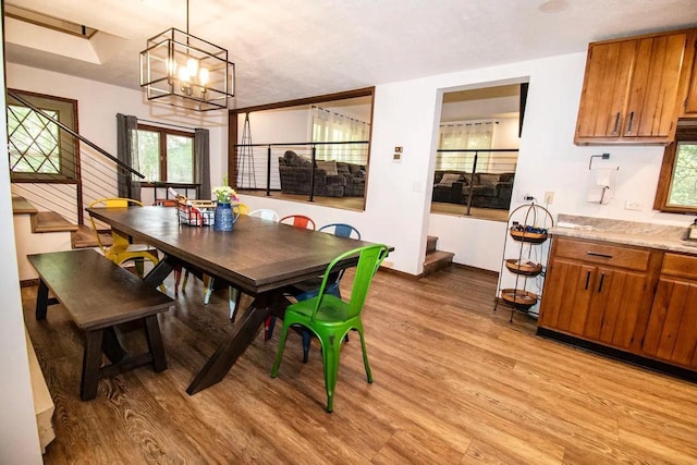 dining room with an inviting chandelier and light wood-type flooring