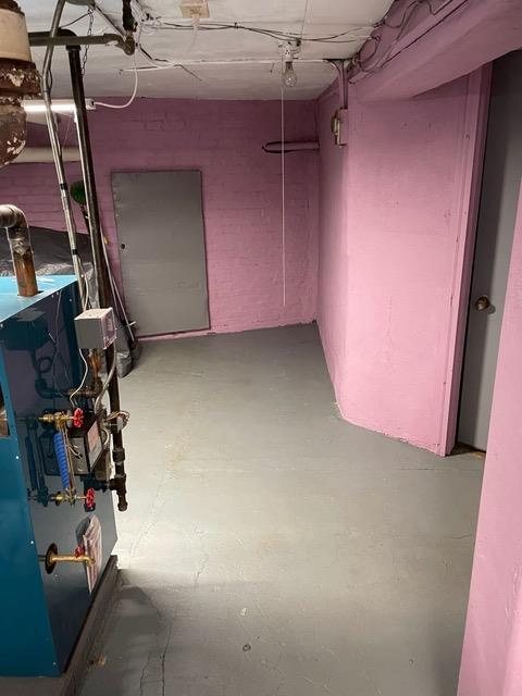 unfinished basement featuring a heating unit