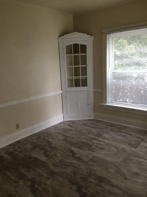 empty room featuring baseboards