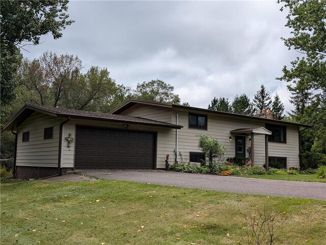 view of front of home with a garage and a front lawn