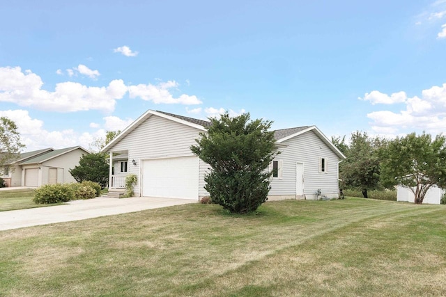 view of side of property with a lawn and a garage