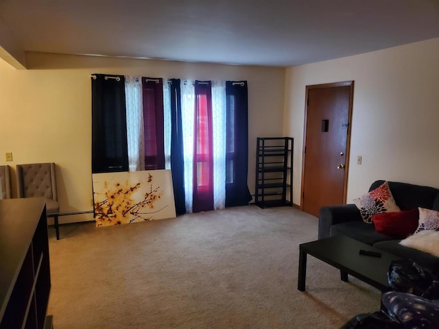 living area with baseboard heating and light colored carpet