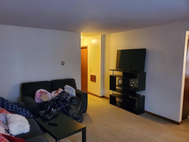 living room with light carpet and baseboards