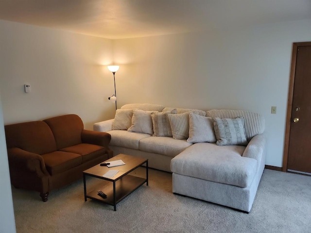 carpeted living room featuring baseboards