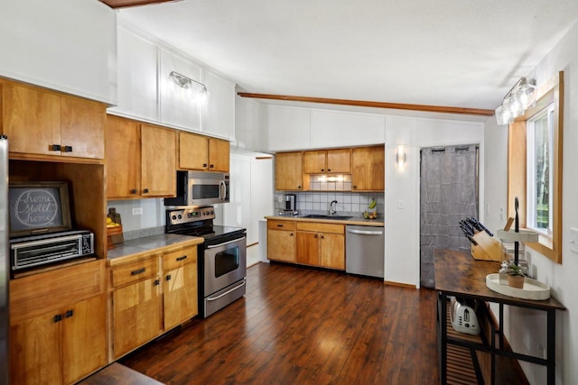 kitchen with ornamental molding, tasteful backsplash, stainless steel appliances, dark hardwood / wood-style flooring, and sink