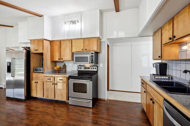 kitchen with dark hardwood / wood-style flooring, stainless steel appliances, sink, and tasteful backsplash