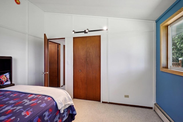 bedroom with a baseboard heating unit and multiple windows