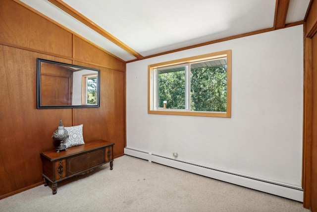 carpeted empty room featuring crown molding, baseboard heating, wood walls, and lofted ceiling with beams