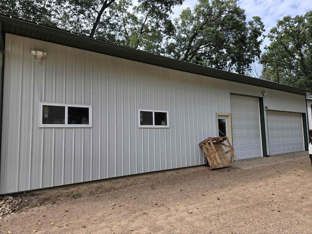 view of property exterior with a garage and an outdoor structure