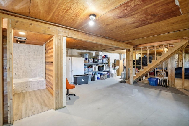 basement featuring wood walls and wooden ceiling