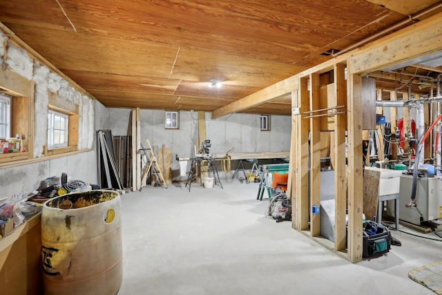 basement featuring wood ceiling and sink