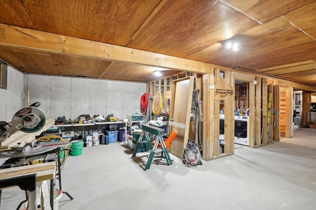 basement with washer / clothes dryer and wood ceiling