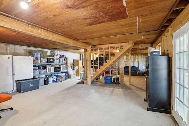 basement featuring white refrigerator and wood ceiling