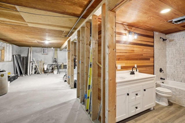 full bathroom with vanity, toilet, bathtub / shower combination, and wooden walls