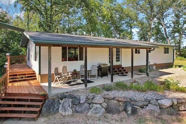 rear view of house featuring a patio and a deck