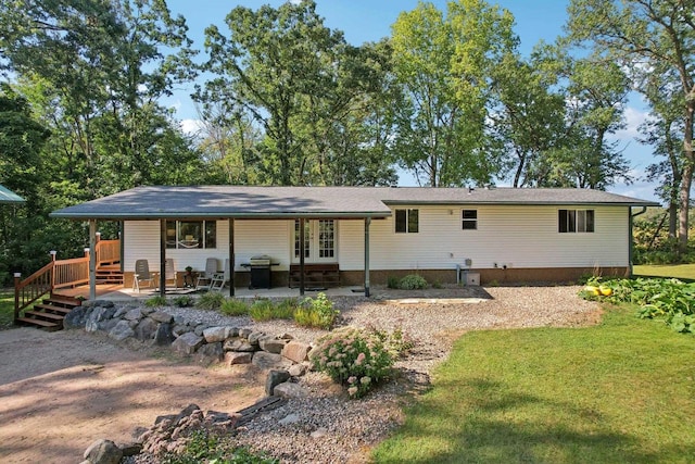 back of house with a lawn and a patio area