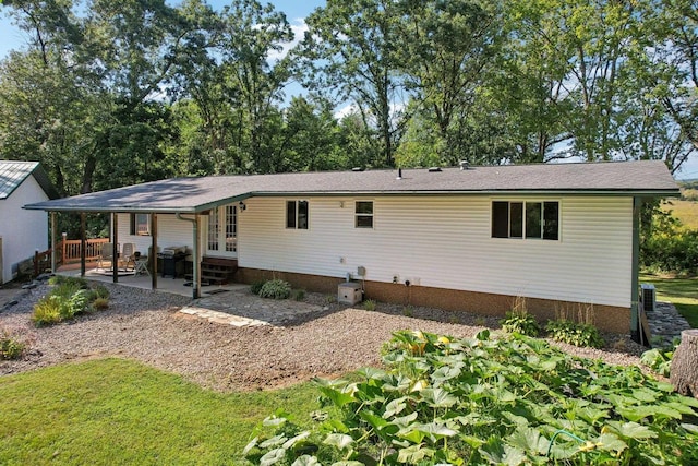 back of property with a yard and a patio area