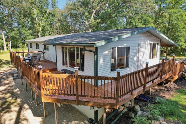 back of property featuring a wooden deck