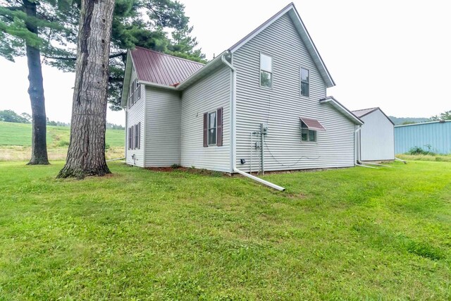 rear view of property featuring a yard