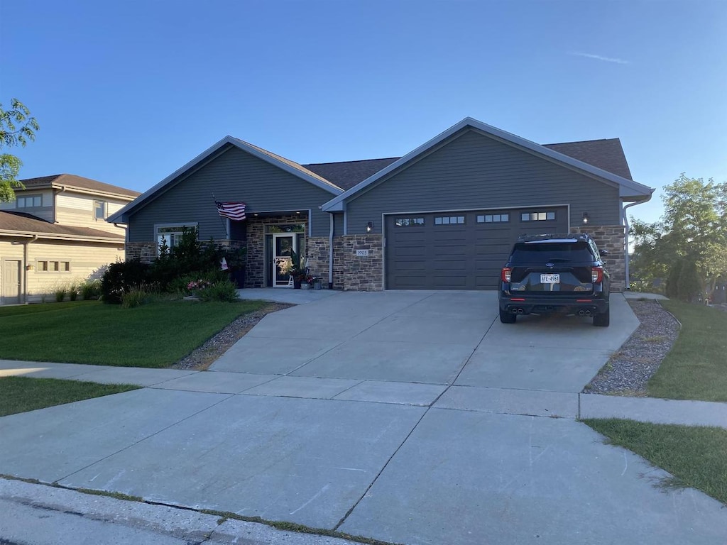 view of front of home featuring a garage and a front lawn