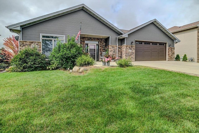 view of front of home with a garage and a front lawn