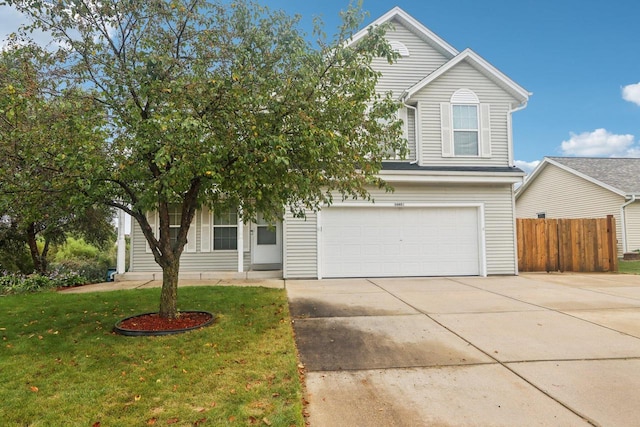 view of front of property with a front yard and a garage