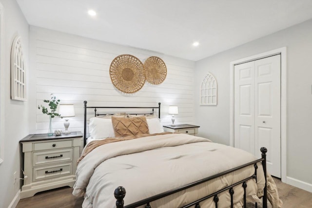 bedroom with dark wood-type flooring and a closet