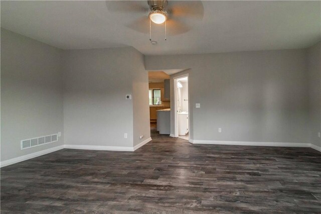 empty room featuring dark hardwood / wood-style flooring and ceiling fan