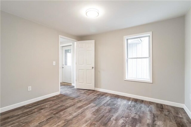 unfurnished room featuring dark wood-type flooring