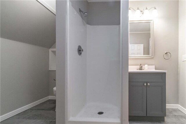 bathroom featuring lofted ceiling, walk in shower, toilet, and vanity