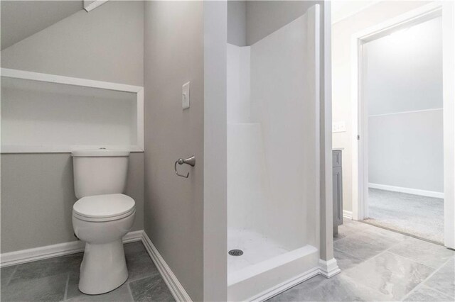 bathroom featuring toilet and walk in shower