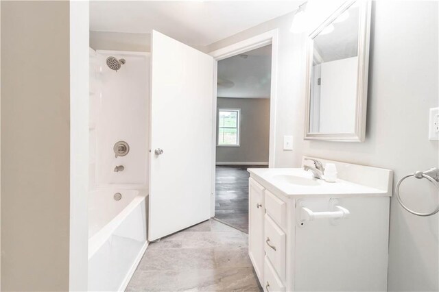 bathroom featuring vanity, hardwood / wood-style flooring, and shower / tub combination