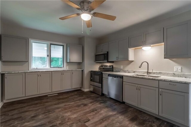 kitchen with gray cabinetry, ceiling fan, stainless steel appliances, and sink