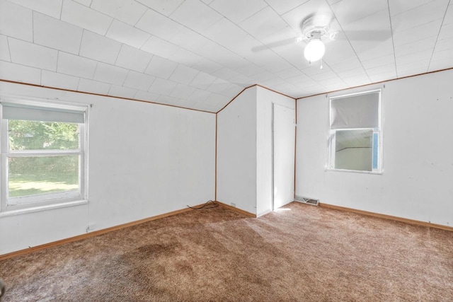 empty room with ceiling fan, carpet, and vaulted ceiling