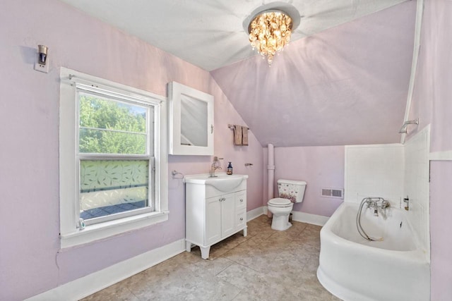 bathroom with vanity, vaulted ceiling, a bath, a notable chandelier, and toilet