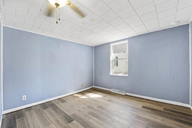 spare room featuring ceiling fan and hardwood / wood-style flooring