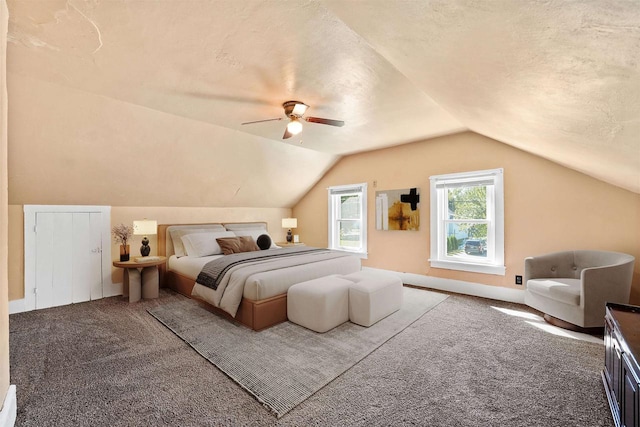 bedroom with a textured ceiling, light colored carpet, ceiling fan, and lofted ceiling