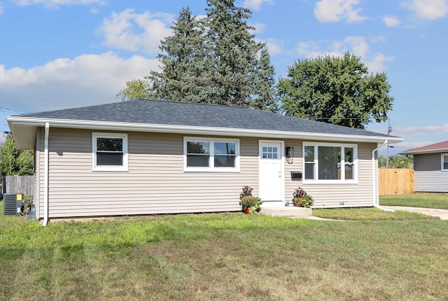 view of front facade with a front yard and central AC