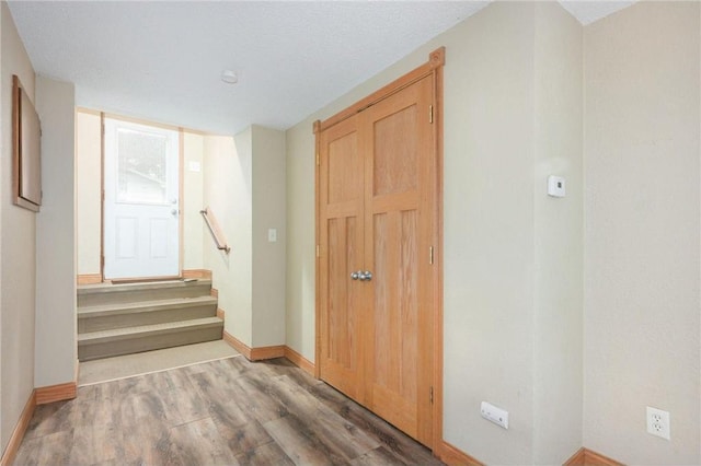 entryway with a textured ceiling and hardwood / wood-style floors