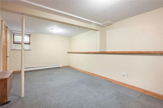 basement featuring a textured ceiling, a baseboard radiator, and carpet flooring