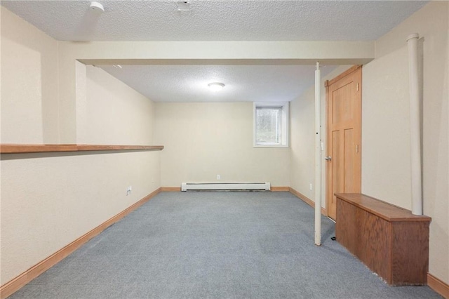 basement with a textured ceiling, carpet flooring, and baseboard heating