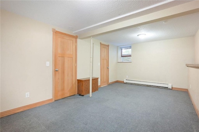 interior space with a baseboard heating unit, a textured ceiling, and carpet