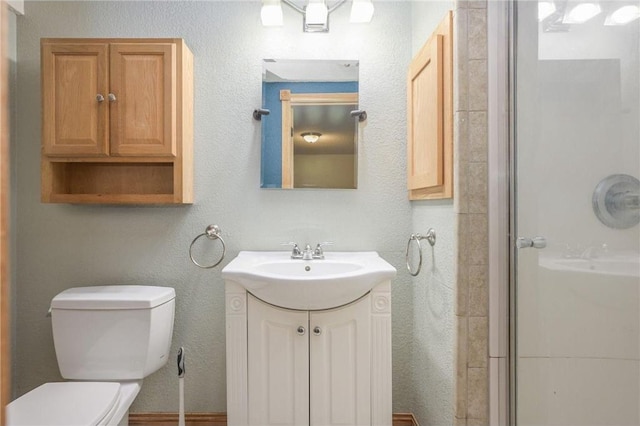 bathroom with vanity, toilet, and an enclosed shower