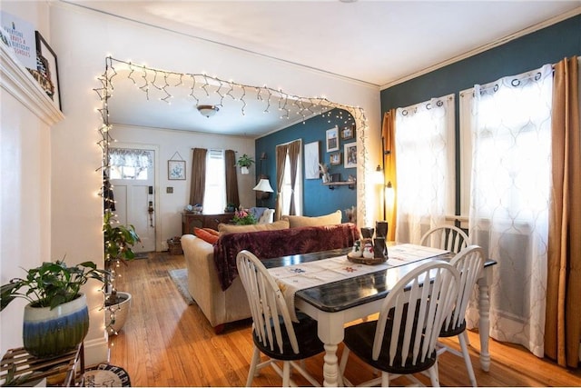 dining area with crown molding and wood-type flooring