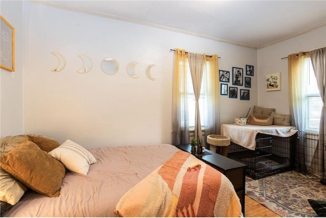 bedroom with crown molding and hardwood / wood-style flooring