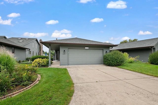 view of front of property with a garage, driveway, and a front lawn