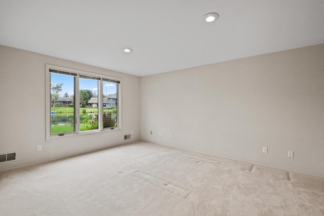 empty room featuring light carpet